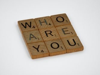 Who are you? written in Scrabble tiles.